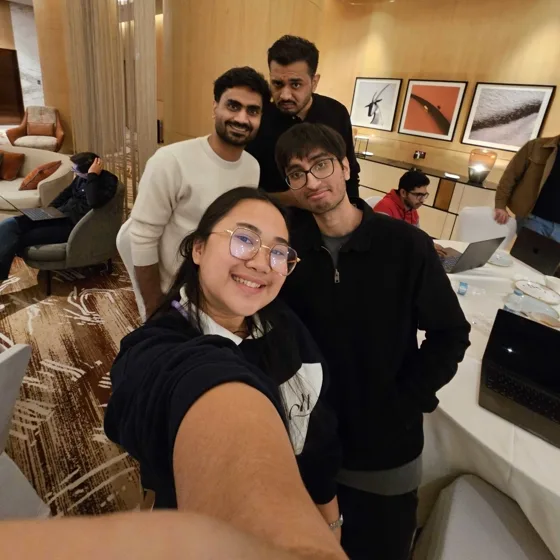 Five teammates in a group selfie at the Doha offsite