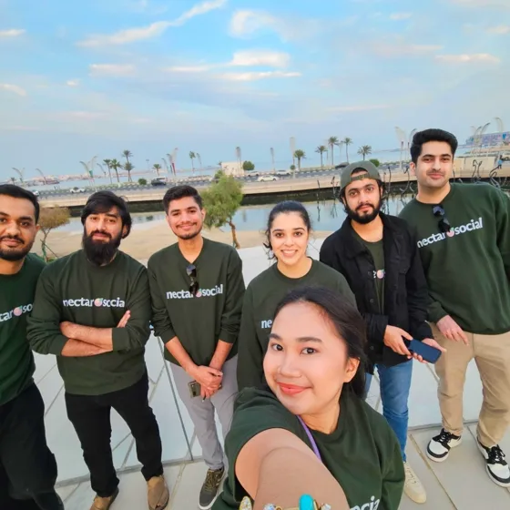 The team in Nectar sweatshirts on the Doha waterfront
